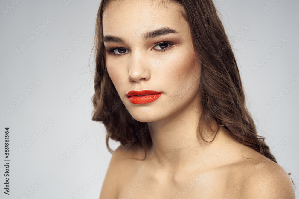 Beautiful woman fashionable hairstyle grooming naked shoulders bright makeup Beautiful woman fashionable hairstyle grooming naked shoulders bright makeup