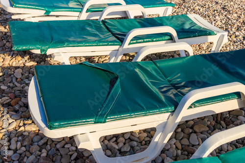 Wallpaper Mural Chaise lounges on a pebble beach. Concept of rest, relaxation, holidays, resort Torontodigital.ca