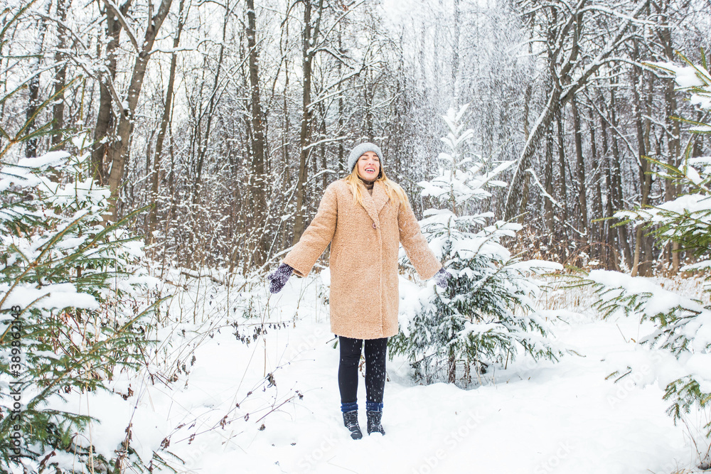 Young woman throwing snow in the air at sunny winter day, she is happy and fun. Young woman throwing snow in the air at sunny winter day, she is happy and fun.