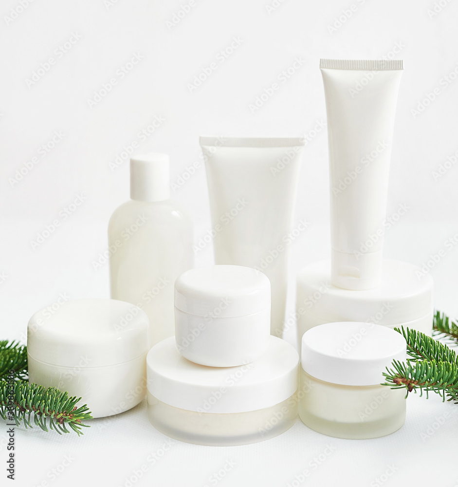 Christmas Beauty cosmetic products sale background. Flat lay composition with makeup products and fir branches on white background. Skin Care & Spa Products. Copy space.