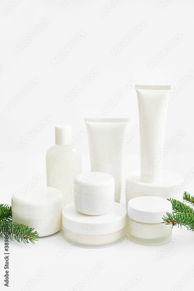 Christmas Beauty cosmetic products sale background. Flat lay composition with makeup products and fir branches on white background. Skin Care & Spa Products. Copy space. Christmas Beauty cosmetic products sale background. Flat lay composition with makeup products and fir branches on white background. Skin Care & Spa Products. Copy space.