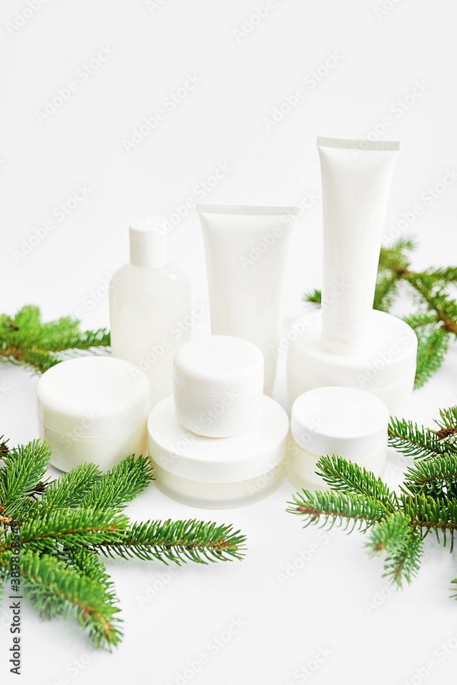 Christmas Beauty cosmetic products sale background. Flat lay composition with makeup products and fir branches on white background. Skin Care & Spa Products. Copy space. Christmas Beauty cosmetic products sale background. Flat lay composition with makeup products and fir branches on white background. Skin Care & Spa Products. Copy space.