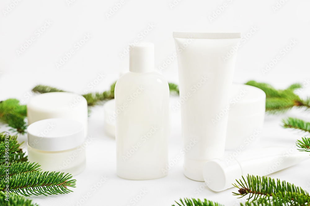 Christmas Beauty cosmetic products sale background. Flat lay composition with makeup products and fir branches on white background. Skin Care & Spa Products. Copy space.