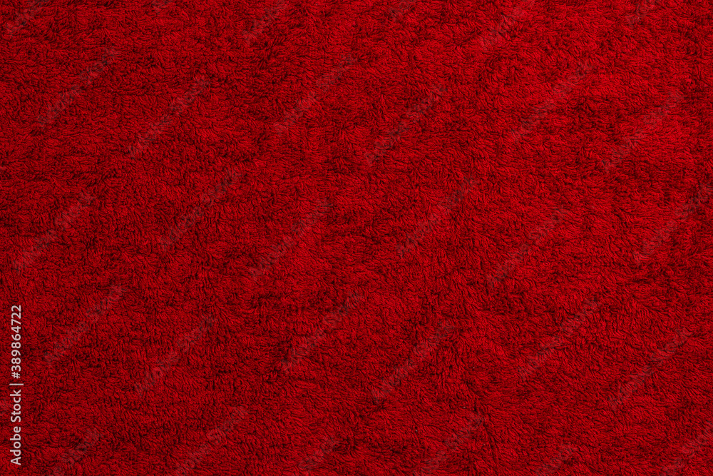 Fototapeta premium red cotton terry towel lies on a flat surface close-up