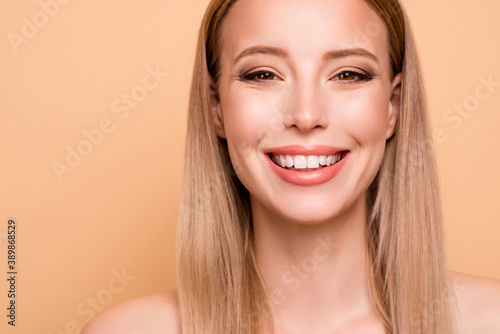 Close up photo of positive cheerful cute charming lad feel satisfied candid toothy fun have moisturizing care treatment long hair pink smooth ideal skin isolated on pastel background