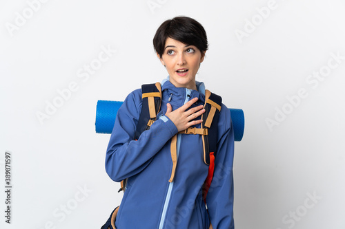 Mountaineer woman over isolated background looking up while smiling