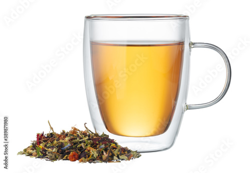 Glass cup of tea with dry tea leaves isolated on white