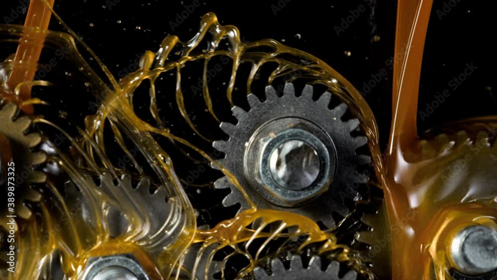 Super slow motion of rotating engine steel wheels with oil splashes. Filmed on high speed cinema camera, 1000 fps.