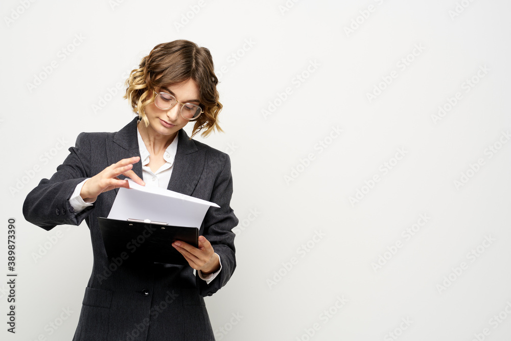 Woman in business suit finances work documents glasses hairstyle Woman in business suit finances work documents glasses hairstyle