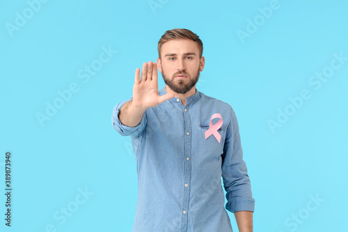 Man with pink ribbon on col...