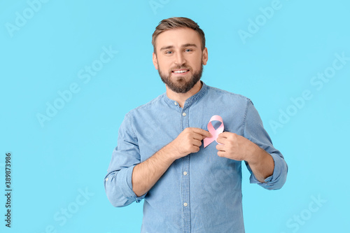 Man with pink ribbon on col...