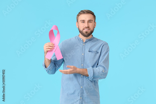 Man with pink ribbon on col...