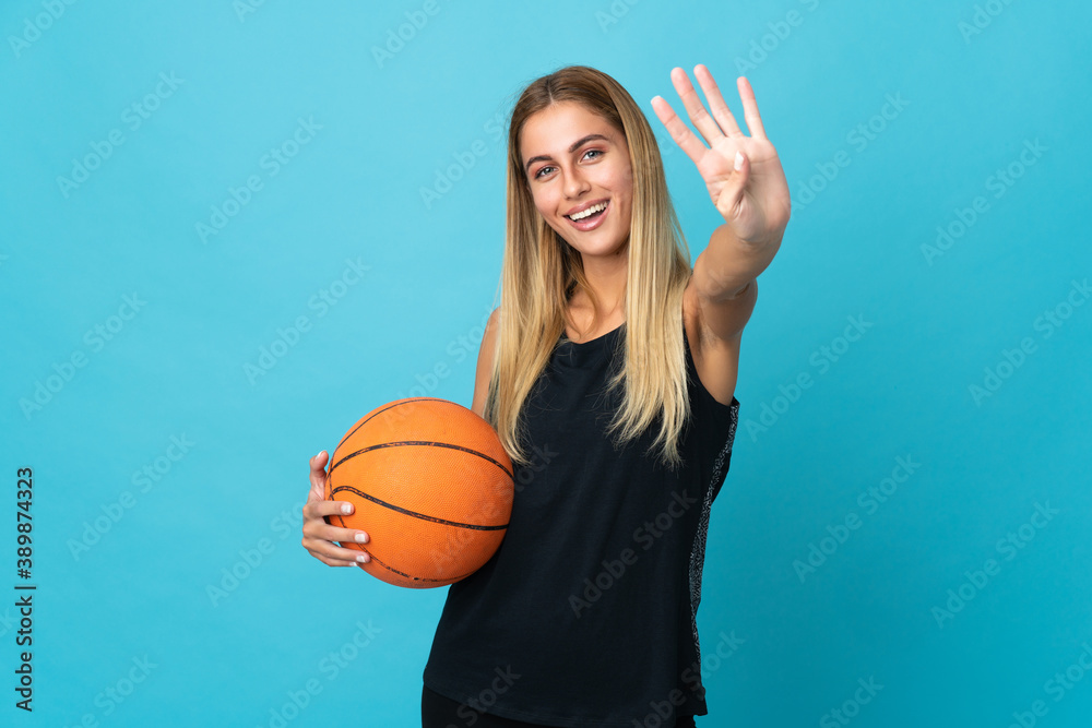 Young woman playing basketball isolated on white background happy and counting four with fingers Young woman playing basketball isolated on white background happy and counting four with fingers