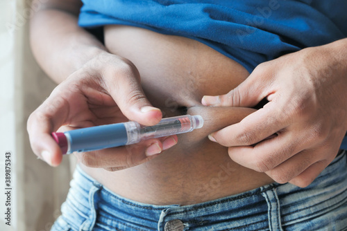 young man hand using insulin pen close up  photo