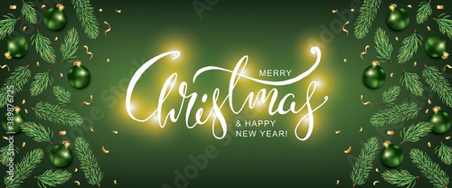 Christmas Green Background with realistic  fir and balls baubles decoration. Christmas Lettering Greeting Card with holidays lights and Xmas Ornaments  photo