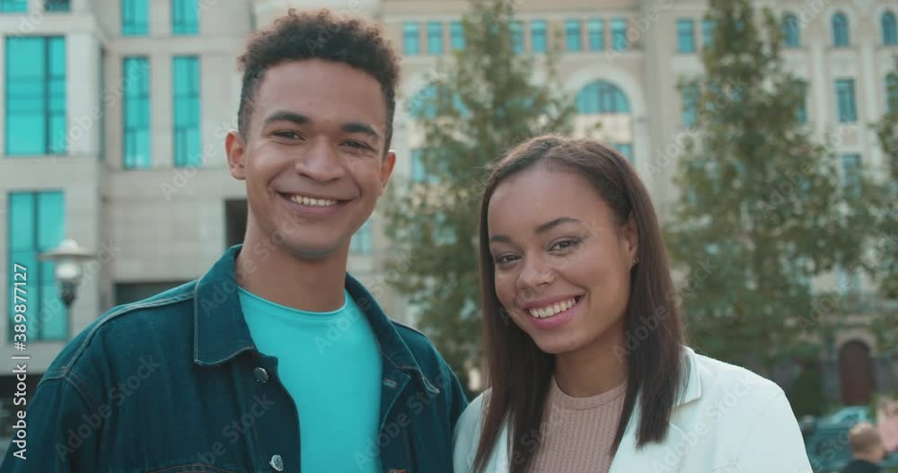 Cheerful mixed-race couple smiling, looking at each other, relationship, love Cheerful mixed-race couple smiling, looking at each other, relationship, love