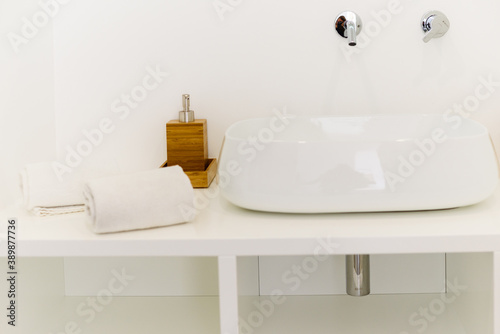 Ceramic Water tap sink with faucet with soap and towel in expensive loft bathroom or kitchen © stormy