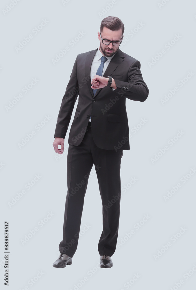 full length . Executive businessman looking at his wristwatch full length . Executive businessman looking at his wristwatch