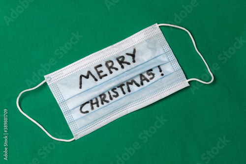 Merry Christmas written on disposable face mask
 photo