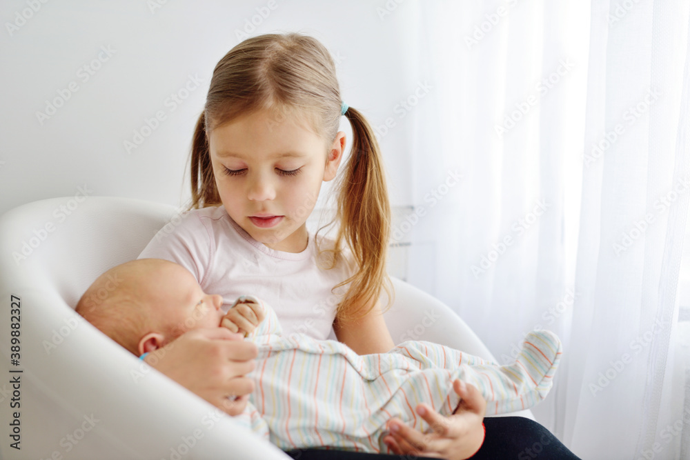 sister holding newborn brother sister holding newborn brother