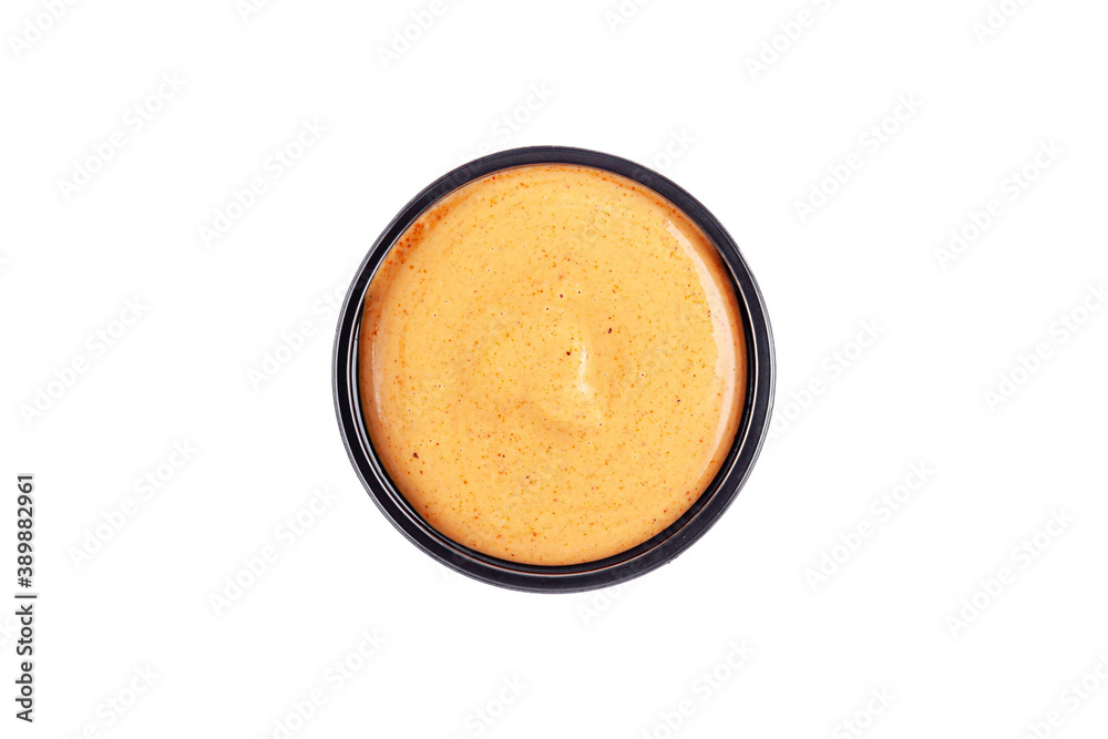 Sauce mustard cheese in a plastic disposable dish on a white background, top view. Isolated Sauce mustard cheese in a plastic disposable dish on a white background, top view. Isolated