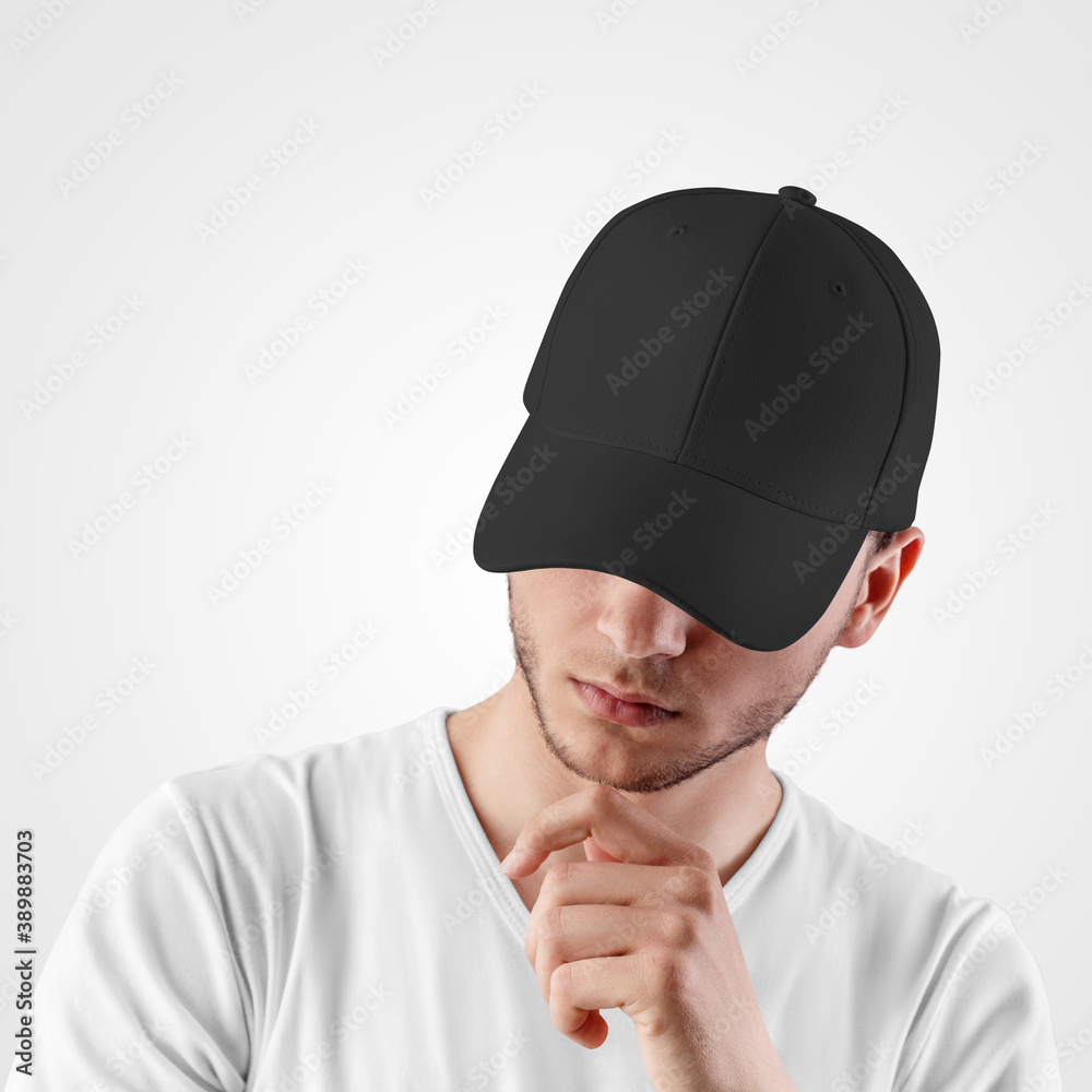 Black baseball cap template for sports, on the head of a guy with a beard, isolated on background. Black baseball cap template for sports, on the head of a guy with a beard, isolated on background.