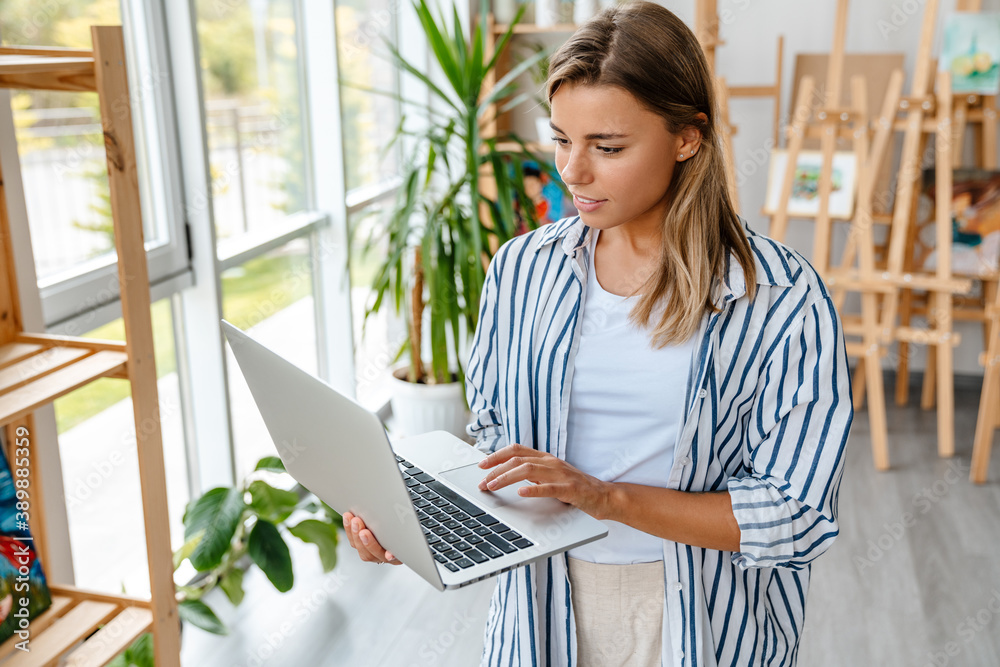 Attractive confident young woman designer working Attractive confident young woman designer working
