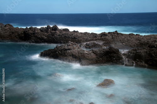 Detail of rocks with waterfalls of ocean water. © JD Jonh y Donoban