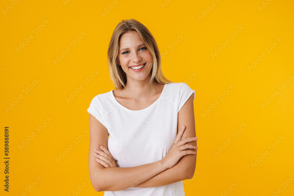 Cheerful beautiful girl smiling while posing with arms crossed Cheerful beautiful girl smiling while posing with arms crossed