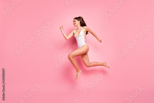 Profile side full body photo of magnificent lady running jumping wear swimwear isolated over pink background