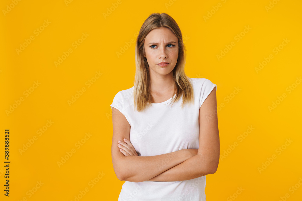 Displeased beautiful girl posing with arms crossed at camera Displeased beautiful girl posing with arms crossed at camera