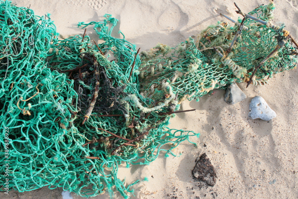 Close up of beautiful fisherman fishing nets string on sandy beach, bird's  eye view of the