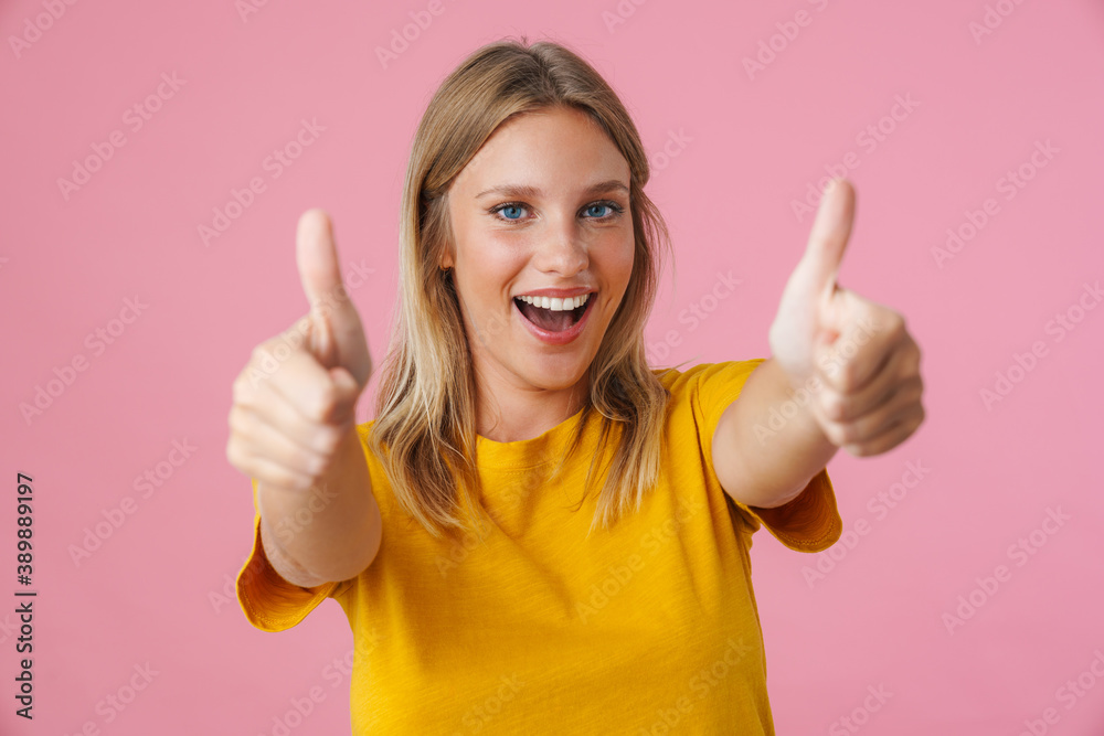 Cheerful beautiful girl smiling and showing thumbs up Cheerful beautiful girl smiling and showing thumbs up