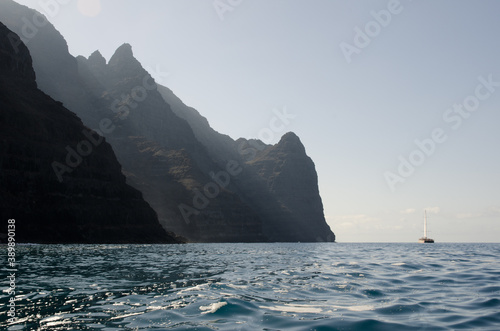 Catamaran and sea cliffs in the Special Natural Reserve of Gui Gui. Aldea de San Nicolas de Tolentino. Gran Canaria. Canary Islands. Spain. photo