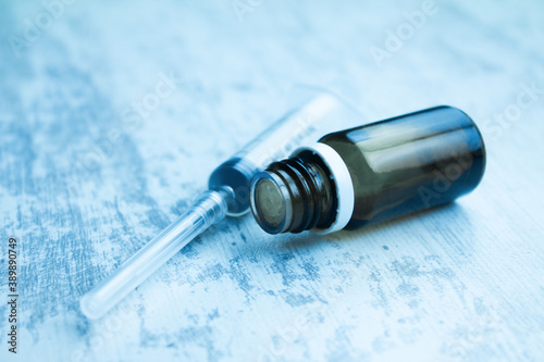 Medical syringe with a needle and a cap with a vaccine.