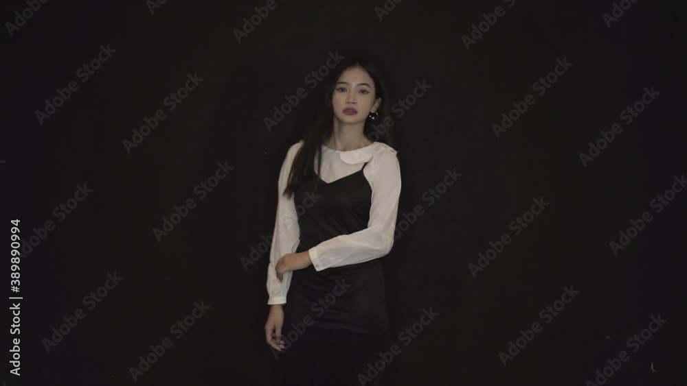 Portrait happy woman smiling dancing to music rhythmically moving her hands. Funny woman having fun, smiling, dancing in studio against black background. Music, dance concept, Teen girl dancing. Portrait happy woman smiling dancing to music rhythmically moving her hands. Funny woman having fun, smiling, dancing in studio against black background. Music, dance concept, Teen girl dancing.