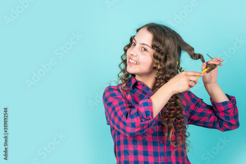 Easy tips making hairstyle for kids. hairdressing tools and hair accessories. kid pose with hair curlers. childhood happiness. happy girl in hair curlers playing hairdresser salon. copy space