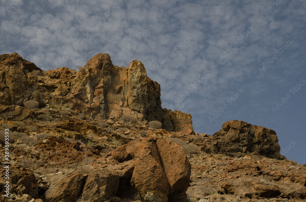 Rocky cliff and clouds in Medio Almud. Mogan. Gran Canaria. Canary Islands. Spain.