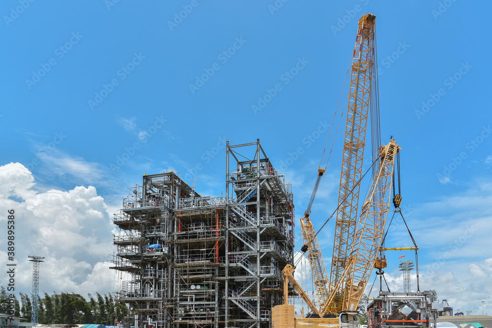 Construction site, Structure platform, power plants and Oil refineries during big crane loading productions in site.