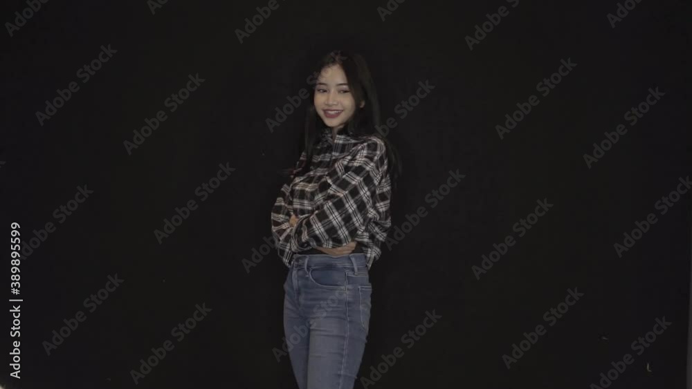 Portrait happy woman smiling dancing to music rhythmically moving her hands. Funny woman having fun, smiling, dancing in studio against black background. Music, dance concept, Teen girl dancing. Portrait happy woman smiling dancing to music rhythmically moving her hands. Funny woman having fun, smiling, dancing in studio against black background. Music, dance concept, Teen girl dancing.
