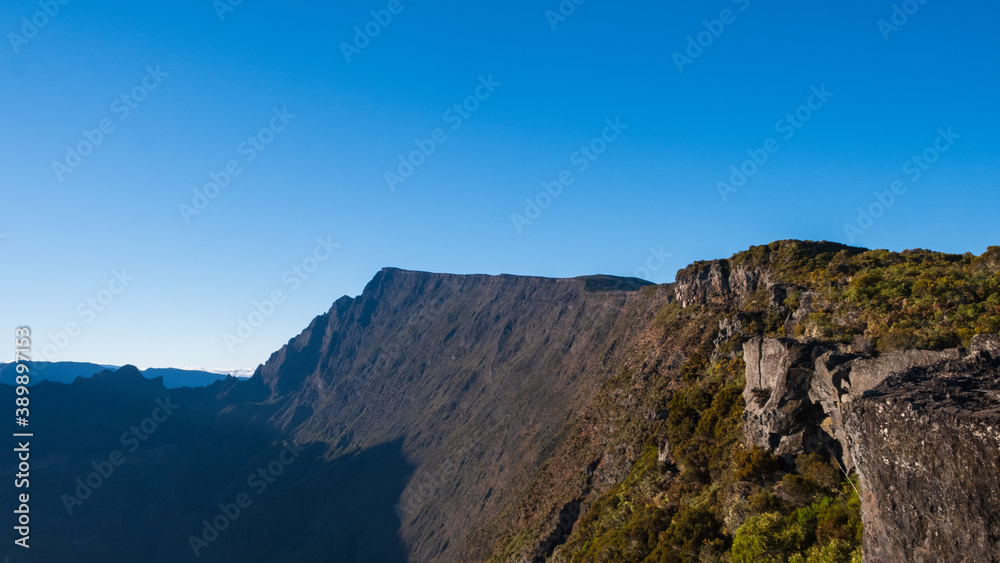 Panoramic view over the mountains of Reunion Island with briar, and a blue sky