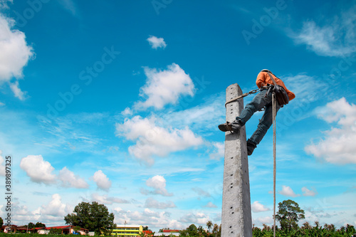 A worker climbed an electric pole to install new equipment.