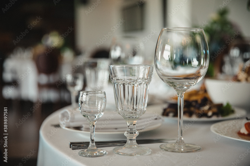 glass goblets and glasses on the serving table for the banquet,
Empty glasses in restaurant