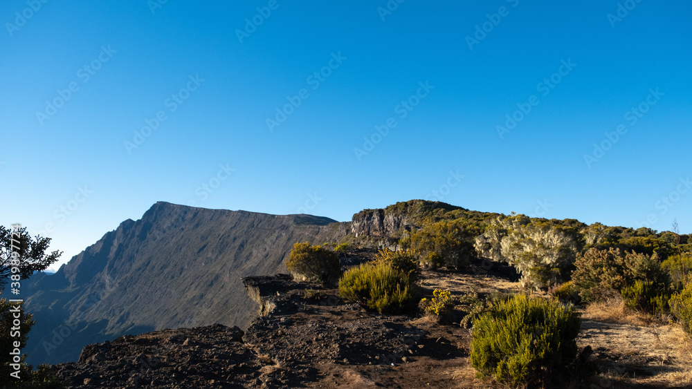 Panoramic view over the mountains of Reunion Island with briar, and a blue sky Panoramic view over the mountains of Reunion Island with briar, and a blue sky