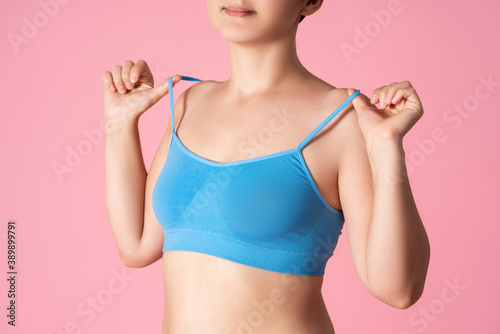 Woman in blue top bra on pink background