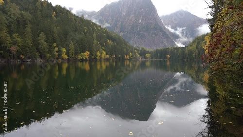 Alpine lake of Piburger See in the Otztal valley in the Austrian Tyrol during autumn, colorful trees in the Alps photo