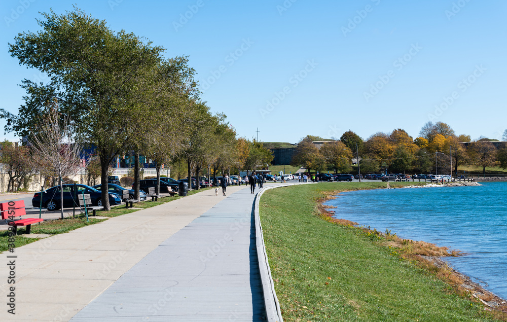 People walking around Castle Island and the Boston Harbor People walking around Castle Island and the Boston Harbor