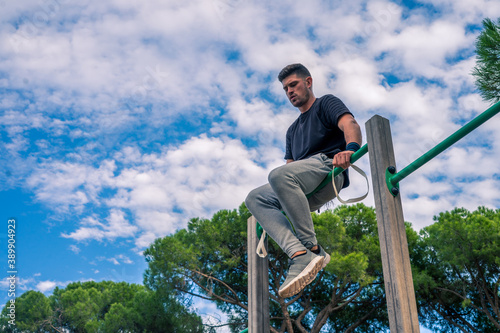 Vertical shot of a handsome sportsman in a park during training photo