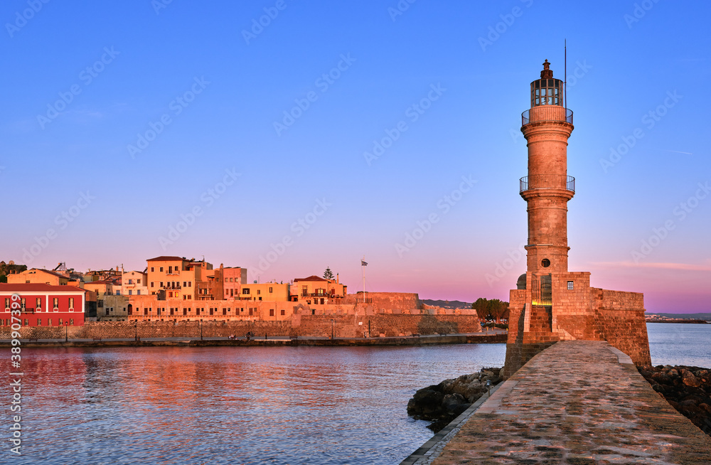 Egyptian or Venetian Lighthouse of Old Venetian harbour of Chania, Crete, Greece at sunrise. Soft sky colors from blue to pink, Firka castle walls.
