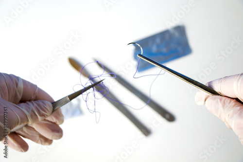 Surgery operation equipment, scalpel, knife, needle and suture. Studio shoot. photo